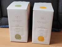 Front view of two unopened Bare Home soap cartons