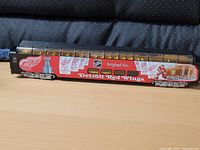 Side view of HO scale Detroit Red Wings passenger car showing graphics and details