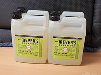 Front view of four identical Mrs. Meyer's Clean Day Hand Soap Refill bottles