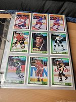 nine cards in sleeve page showing rookie cards Eddie Belfour, Ken Hodge, Rob Blake, Bobby Holik, Sergei Fedorov, Jaromir Jagr
