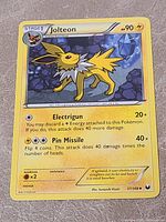 Front of Jolteon card shows artwork, attacks, set and number