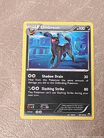 Front of Umbreon card showing artwork, attacks and stats