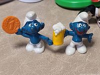 Both Smurf figures standing upright