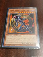 Front of Dark Magician of Chaos card in sleeve showing artwork, stats and set code SR08-EN015