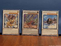 Front view of three sleeved Yu-Gi-Oh Synchro Monster cards