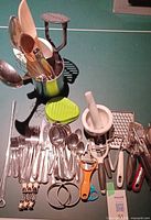 Full layout of assorted utensils, cutlery, skewers and tool holder on table