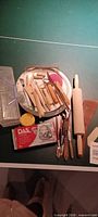 Overview of clay pack, tools, sponge, plate, rolling pin, brushes, storage box