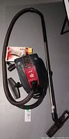 Full view of Dirt Devil Jag 3 canister vacuum cleaner with hose, wand, floor nozzle, accessory tools, and replacement bag