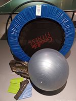 Group shot showing trampoline, Swiss ball, hula hoop, resistance bands and dumbbell case