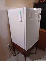 Front and left side of white Galanz upright freezer showing overall condition