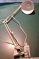 Full view of lamp with clamp base, spring arms, cord, shade