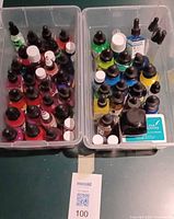 Two bins filled with assorted ink bottles and three ink pads