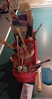 Tray of numerous brushes with blue Princeton wedge visible