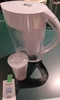 Pitcher with installed filter and loose replacement cartridge