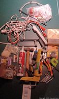 All items laid out including tools, cords, hardware