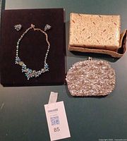 Necklace, earrings, gold evening bag, silver clutch overview