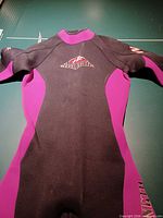 Front view of full wetsuit showing color scheme and logo