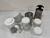 Group view of bowls, jars, French press, utensil holder, grater