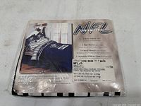 Front of sealed package showing NFL Home Team branding and list of contents