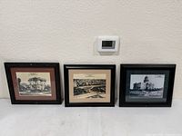 Three framed historical Sacramento photo prints lined up against wall