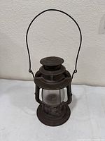 Full view of lantern front showing handle and globe