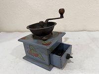 Front angle showing painted base, metal bowl, open drawer