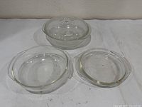 Three clear glass casserole dishes in graduated sizes
