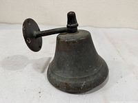 Oblique view of bell showing bell body, arm, mounting plate and striker