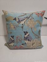 Front view of square bird and floral jacquard pillow