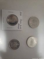 Three 1974 Canadian dollars, one in flip, two loose