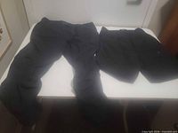 Pants and shorts laid flat on table, full view