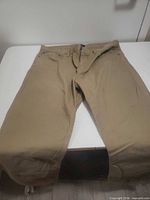 Front view of khaki pants laid flat