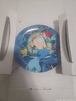 Front view of Bradford Exchange Little Mermaid plate in packaging