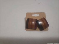 front view of striped acrylic stud earrings on card