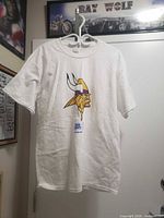 Front view of white T-shirt displaying Minnesota Vikings logo and Bud Light graphic