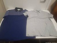 Both polo shirts laid flat front view