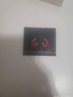 Front view of both lobster earrings on Chelsea Jewelry card