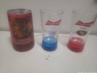 Front view of Blackhawks mug, two Budweiser cups showing team logos