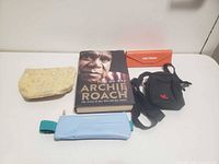 Group shot of book and four pouches/case