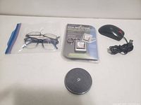 All items laid out: keychain, mouse, charger, glasses