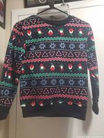 Front view of navy holiday sweatshirt with Santa, snowflake and heart pattern