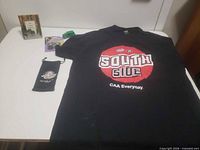 Overview of lot with T-shirt, pouch, hooks pack, frame, toy car