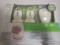 Front of sealed retail box showing three monitor units and feature list