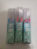 Front view of three packaged audio cables