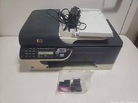 Printer front view showing control panel, output tray, bagged ink cartridge