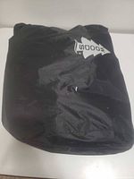 Collapsed air mattress inside black storage bag