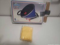 Front of retail box showing Intex bellows air pump illustration with loose yellow hose bagged beside