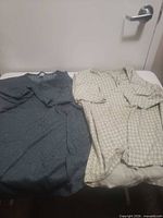 Both shirts laid out side by side on table