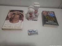 Lot overview showing both books, ceramic shakers and eyelash case