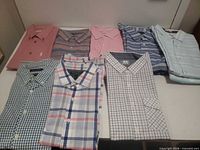 Overview of all ten shirts folded on table